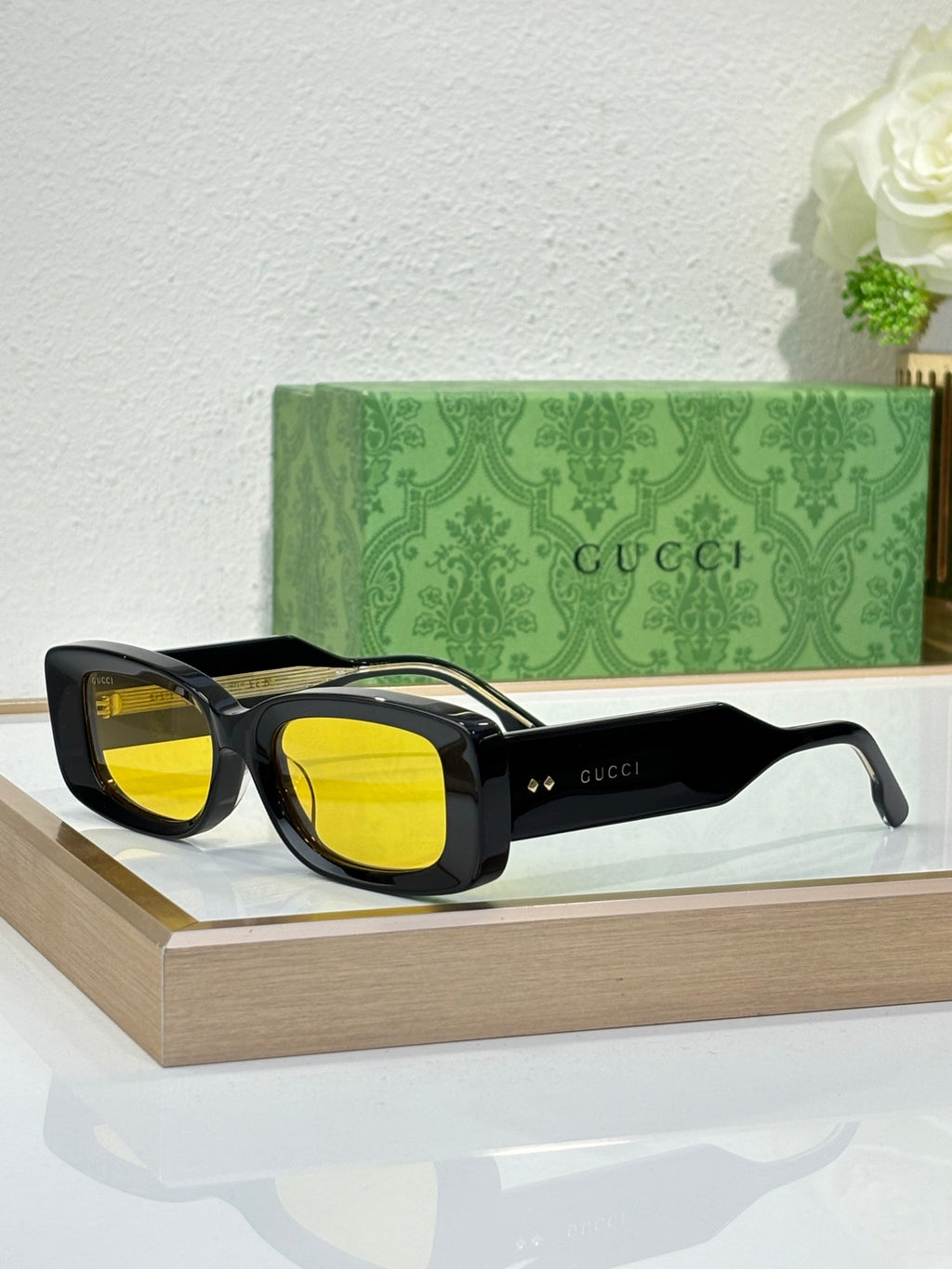 Gucci sunglasses with black frames and yellow tinted lenses