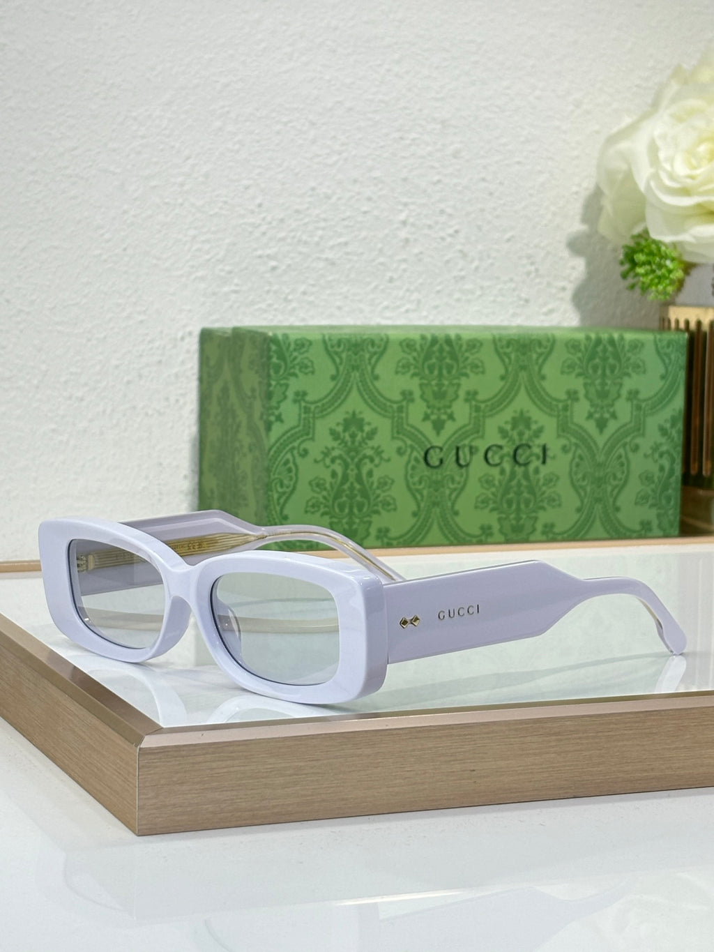 Gucci sunglasses with white frames and clear tinted lenses