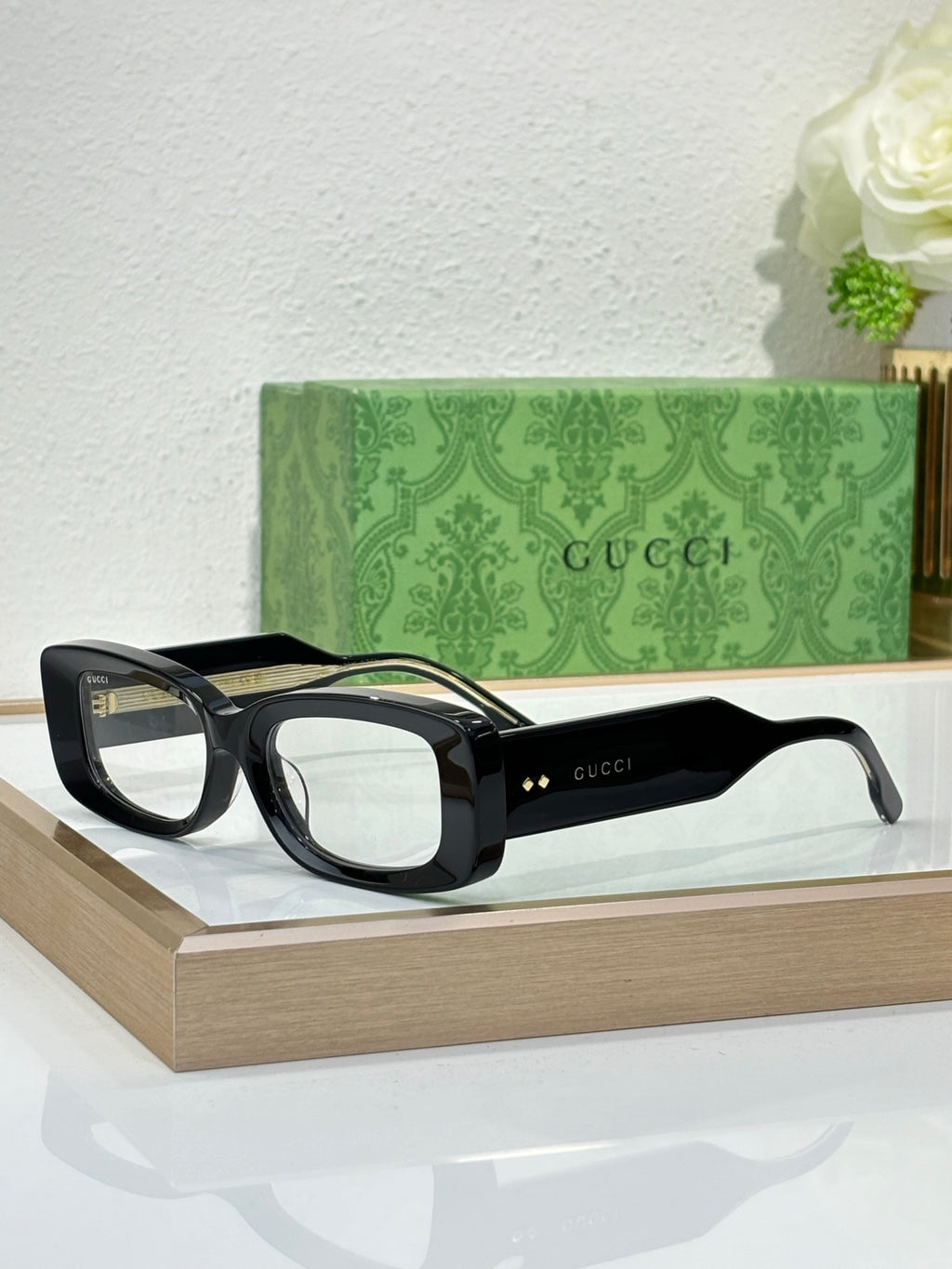 Gucci sunglasses with black frames and transparent light lenses