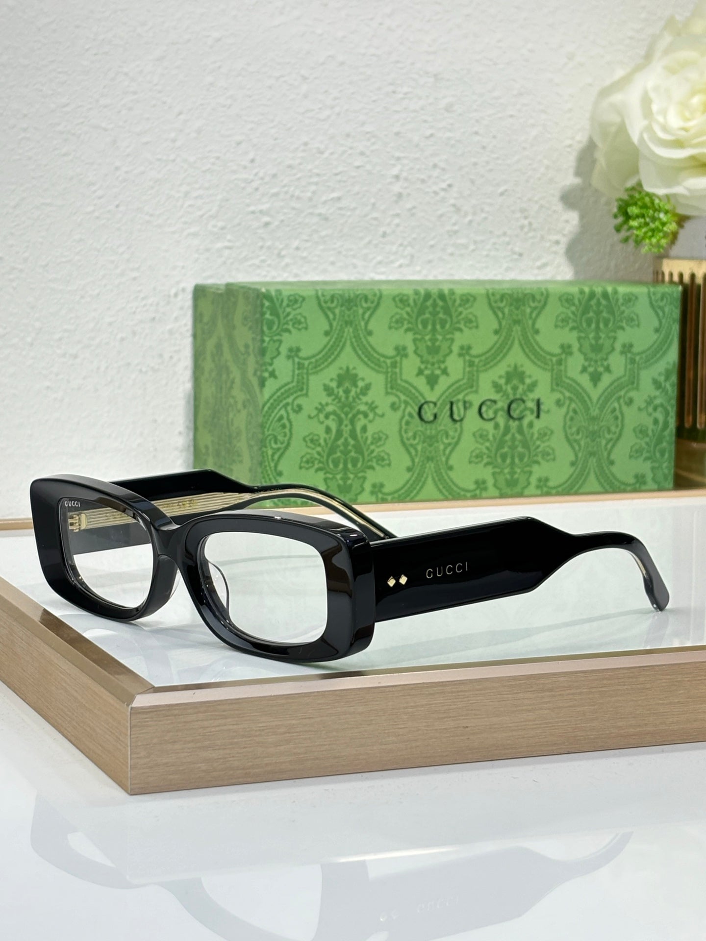 Gucci sunglasses with black frames and transparent light lenses