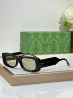 Gucci sunglasses with black frames and light tinted lenses