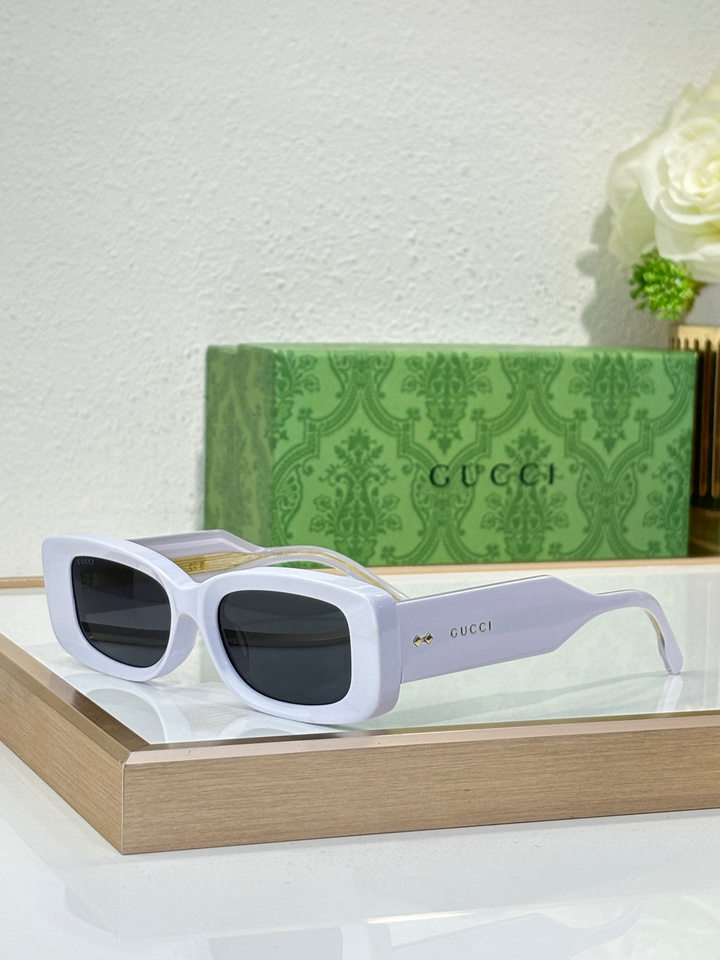 Gucci sunglasses with white frames and dark rectangular lenses