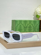Gucci sunglasses with white frames and dark rectangular lenses