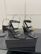 Black heeled sandal pair with gold chain detail and open toe straps