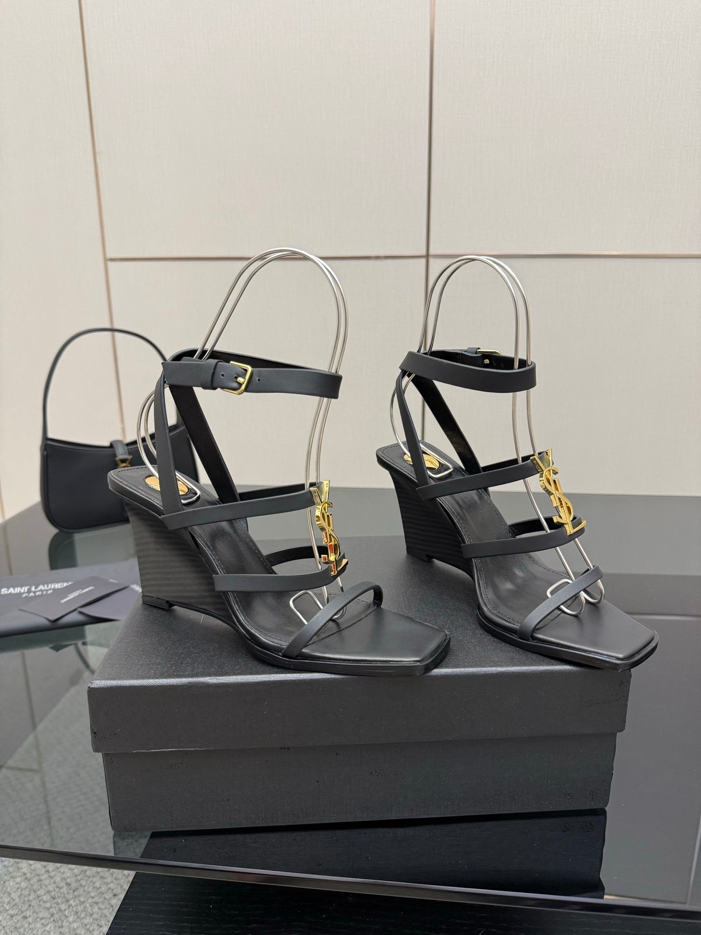 Black heeled sandal pair with gold chain detail and open toe straps