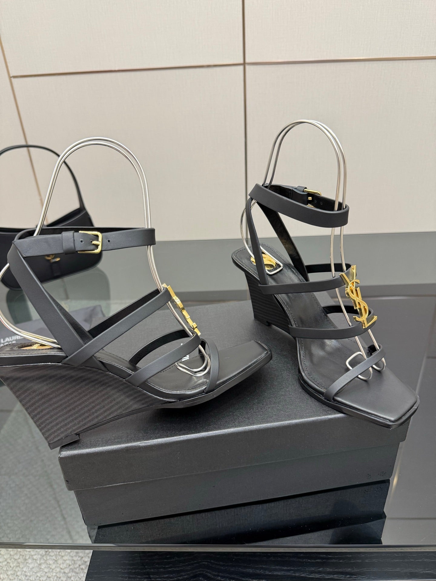 Black heeled sandals with gold chain detail, open toe and crisscross straps