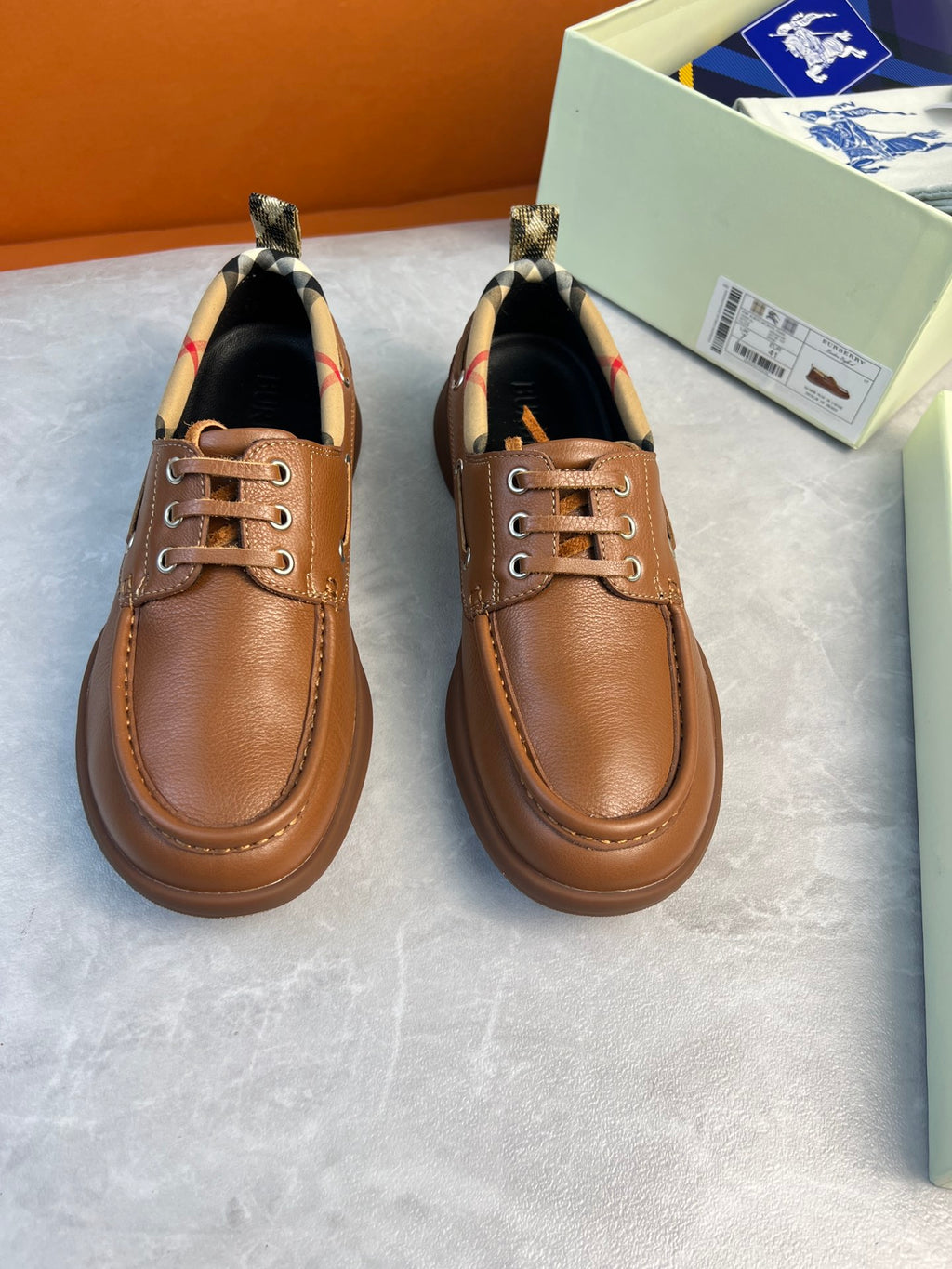 Burberry brown leather lace-up boat shoes with checkered lining and stitched moc toe