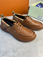Burberry brown leather lace-up boat shoes shown from side view with checkered collar lining