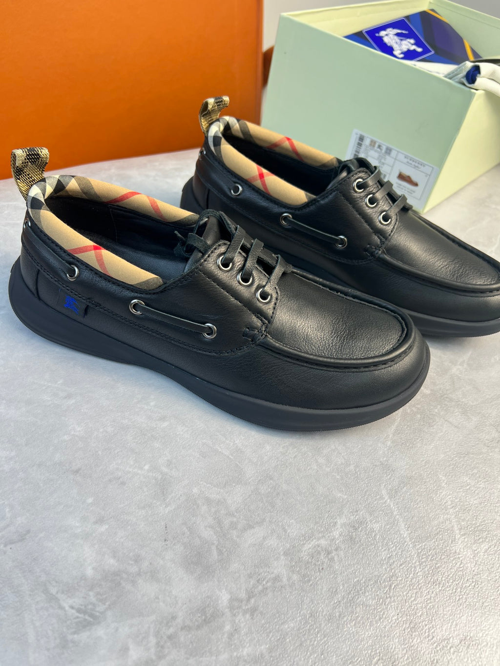 Dark lace-up leather shoes with plaid lining and low-profile sole