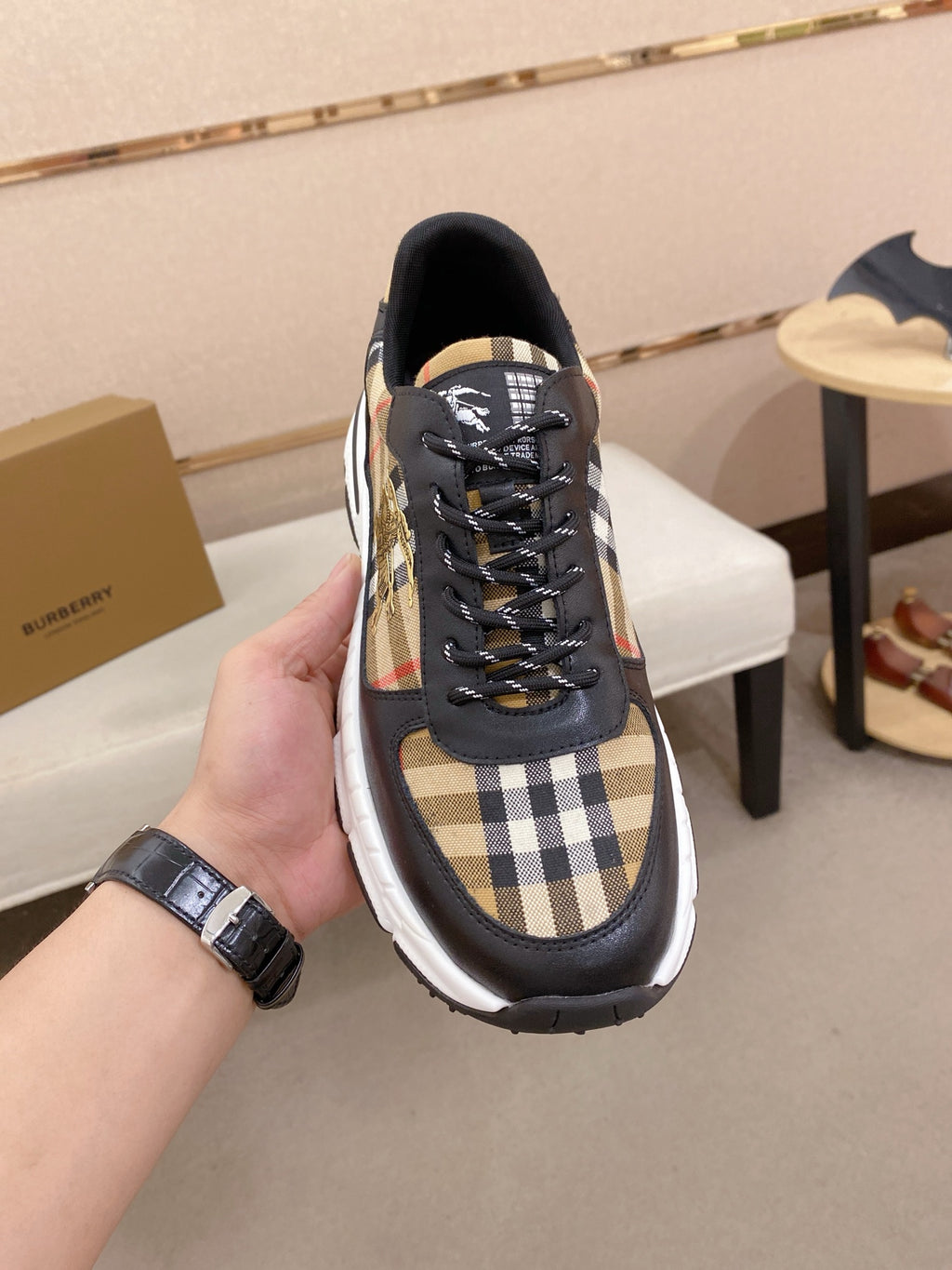 Burberry lace-up sneakers close-up, black uppers with plaid side inserts and laces