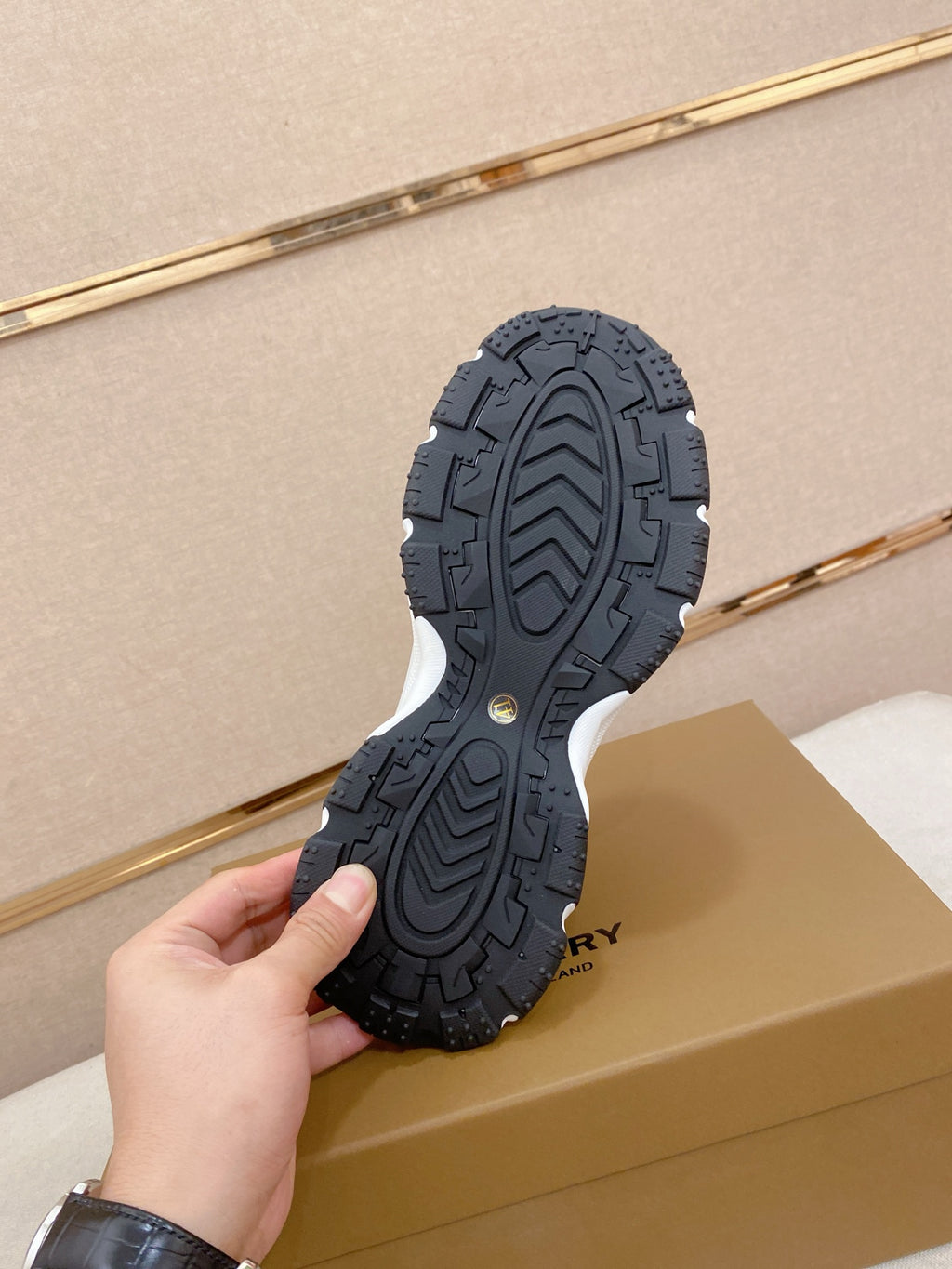 Burberry outsole, dark textured rubber tread with raised circular traction lines