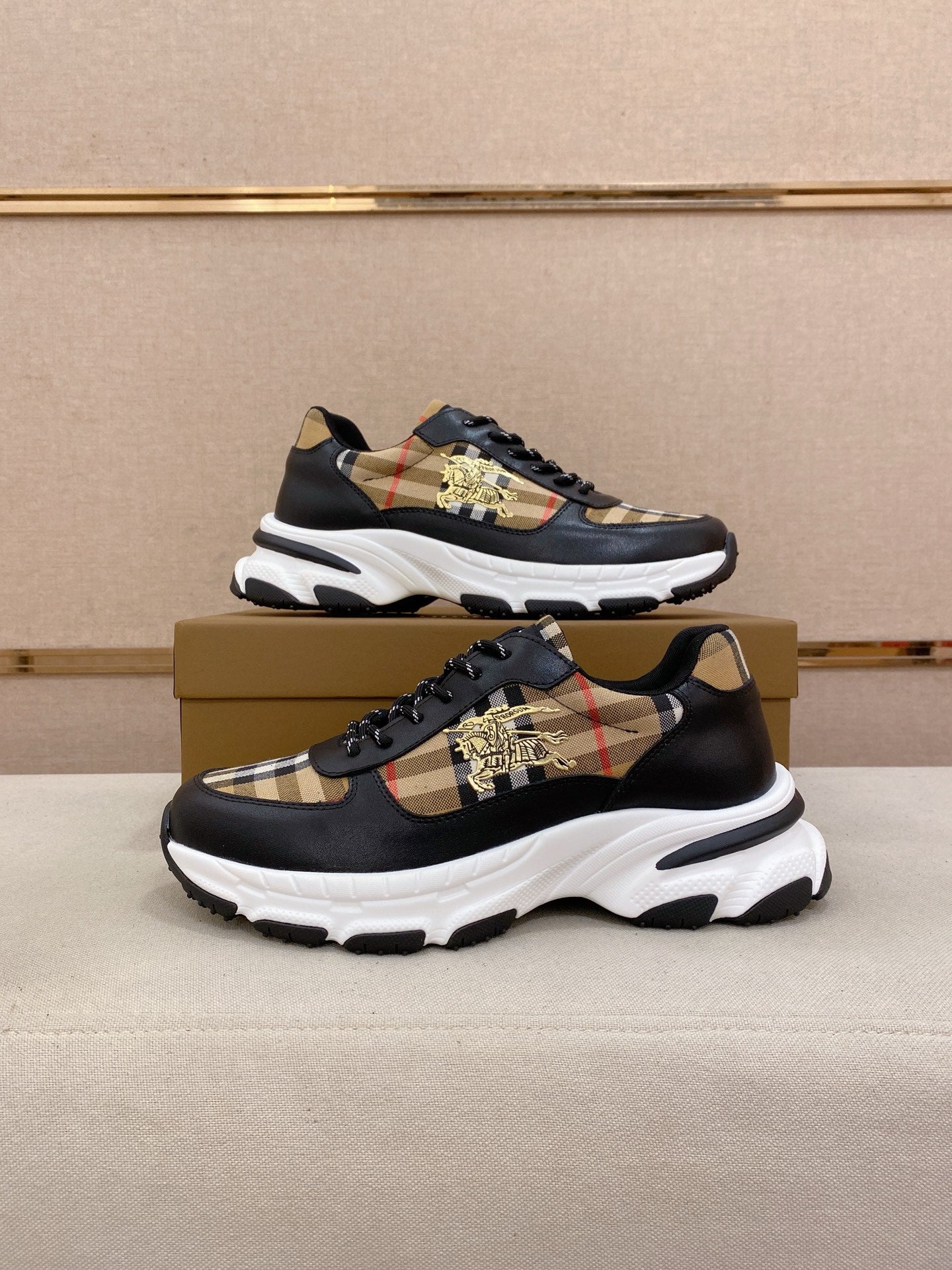Burberry lace-up sneakers pair view, black with beige plaid panels and gold emblem