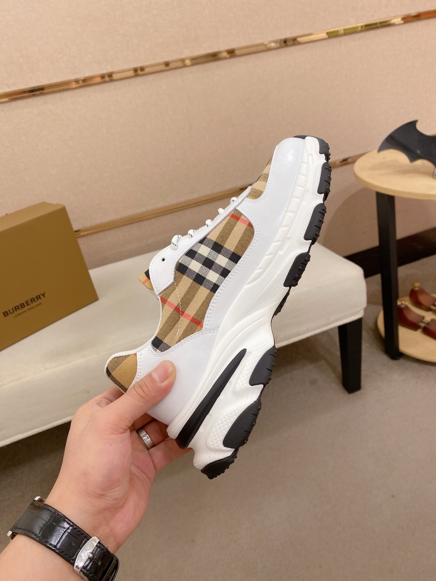 Burberry luxury sneakers, side profile with plaid insert and thick rubber sole
