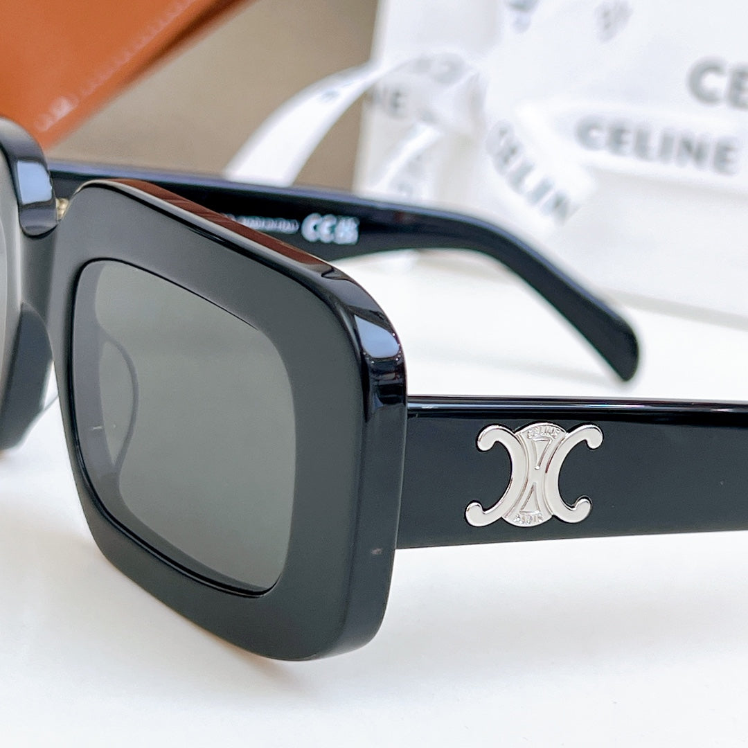 Close-up of black sunglasses with dark lenses and silver CC logo on temple