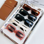 Assorted square sunglasses set in a clear case, showing black, white, and tortoise frames