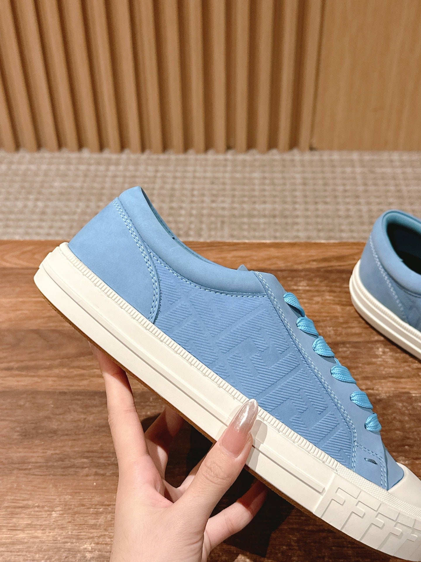 Fendi unisex sneakers side view, light blue suede with embossed texture and blue laces