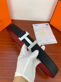 Hermes belt in dark textured leather with silver H buckle, shown on hand