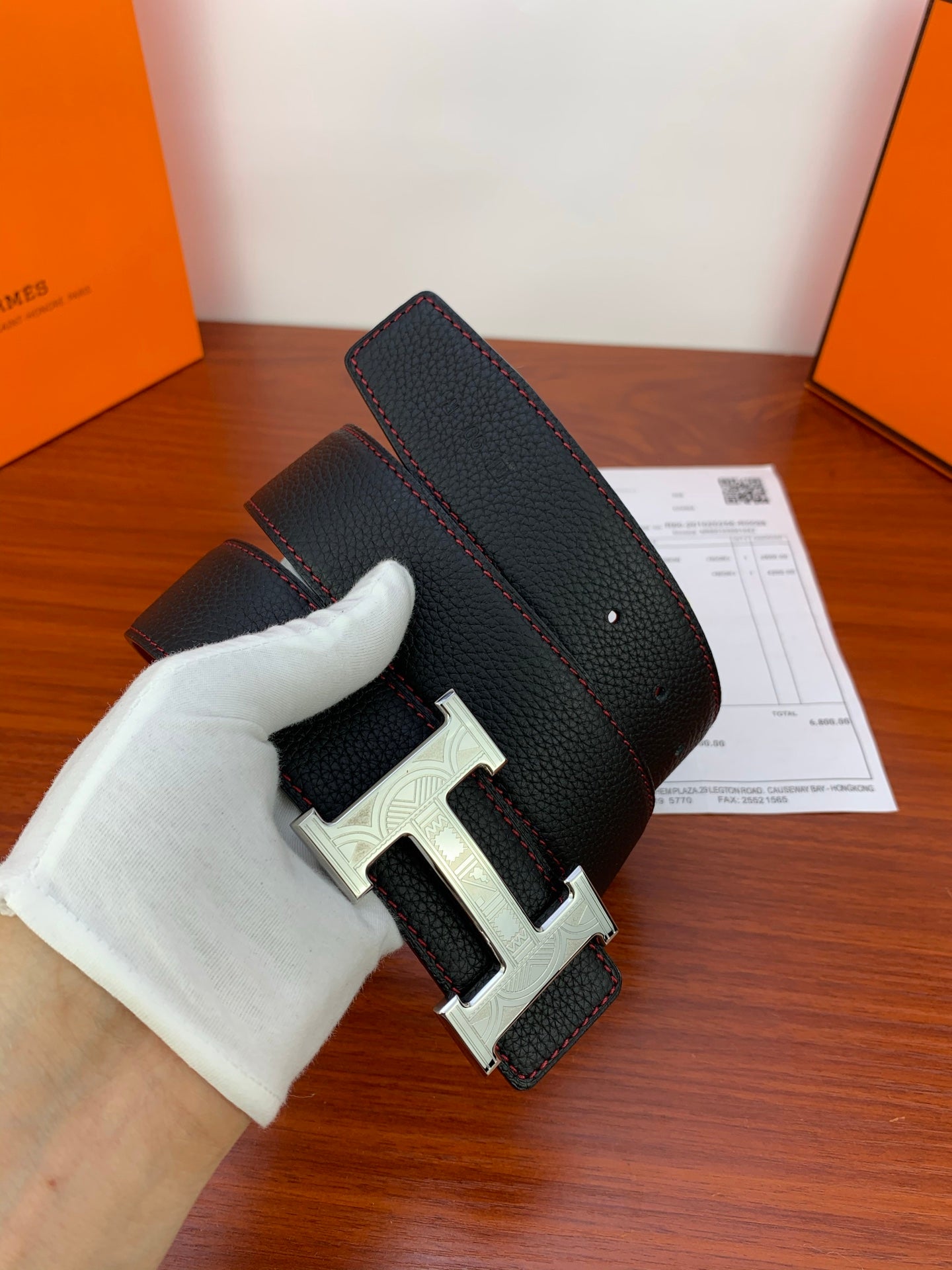 Hermes belt with dark textured strap and silver-toned H buckle