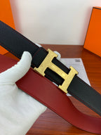 Hermes belt close-up: dark textured leather with gold-toned engraved H buckle