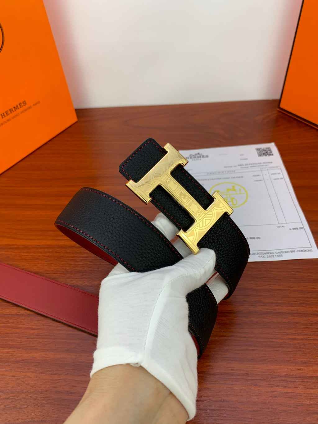Hermes belt with dark textured strap and gold-toned H buckle