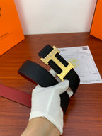 Hermes belt with dark textured strap and gold-toned H buckle