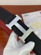 Hermes belt close-up: dark textured leather with engraved silver H buckle