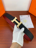 Hermes leather belt, black textured strap with gold H buckle and red underside