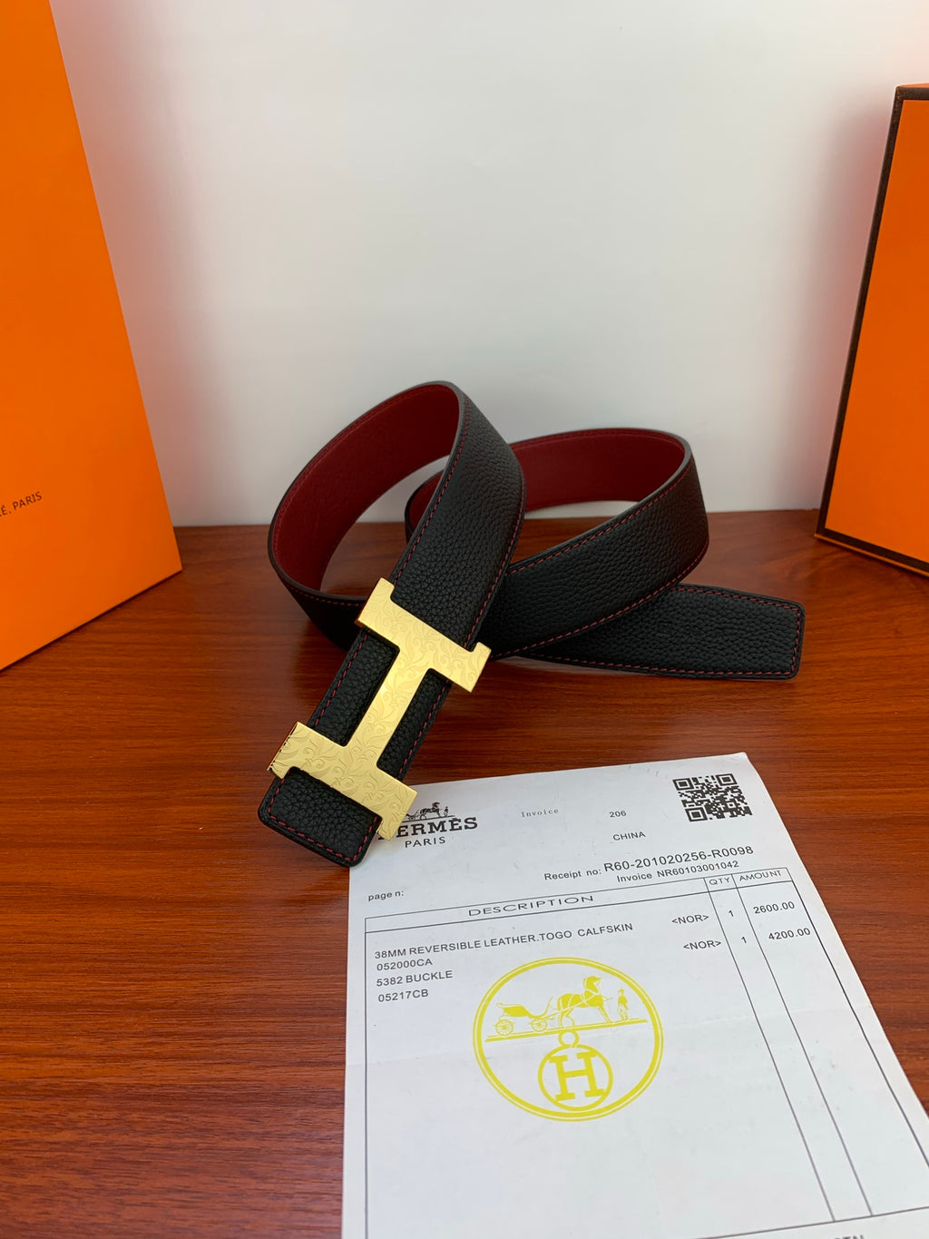 Hermes leather belt with gold rectangular buckle, black strap and red lining