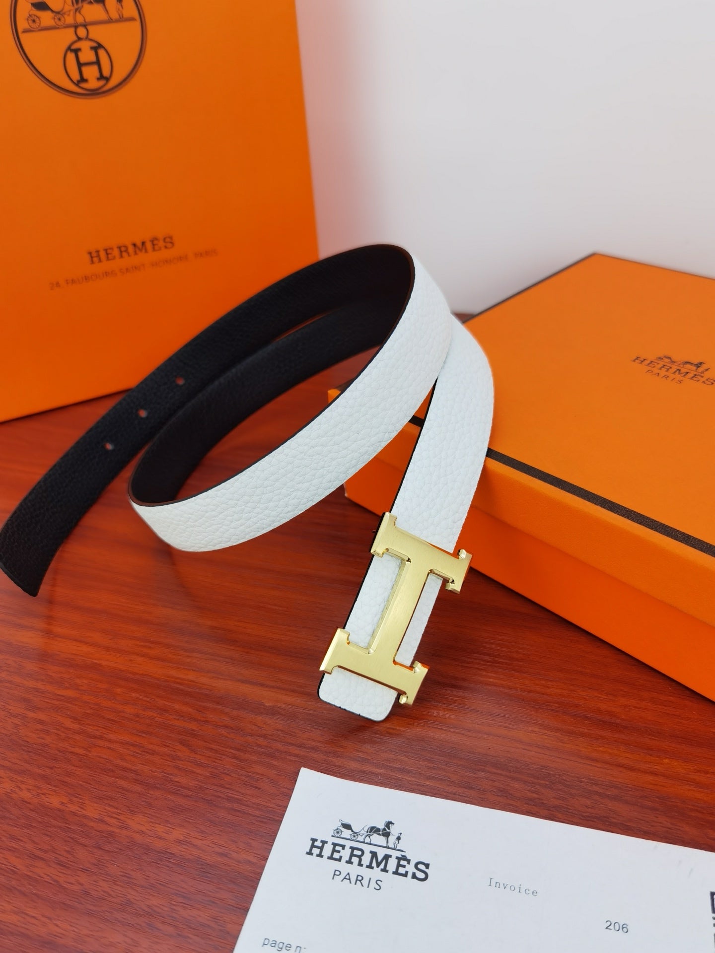 Hermes reversible belt with white leather strap and black reverse, gold H buckle