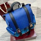 Blue Gucci backpack bag with black front straps, top handle loops, metallic buckles