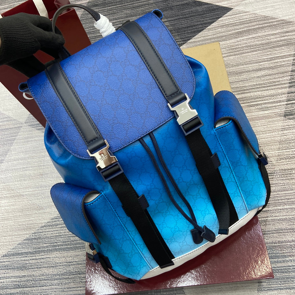 Gucci men’s backpack front with bright blue leather, black strap system, and white edge