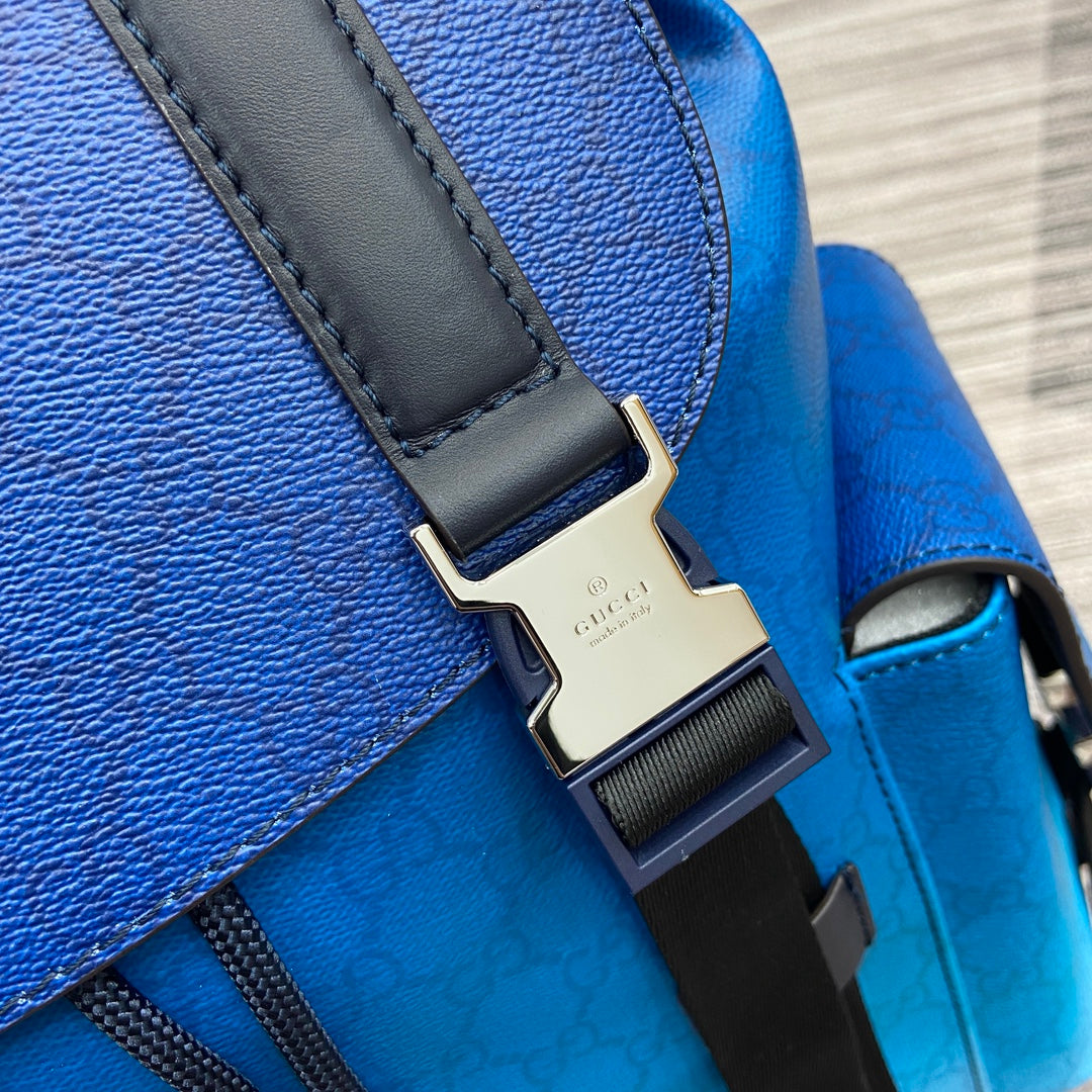 Gucci men’s backpack close-up of metal buckle on bright blue leather and black strap