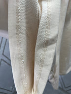 Cream shorts with textured fabric and vertical stitched panels