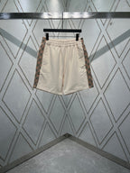 Cream elastic-waist drawstring shorts with front pockets