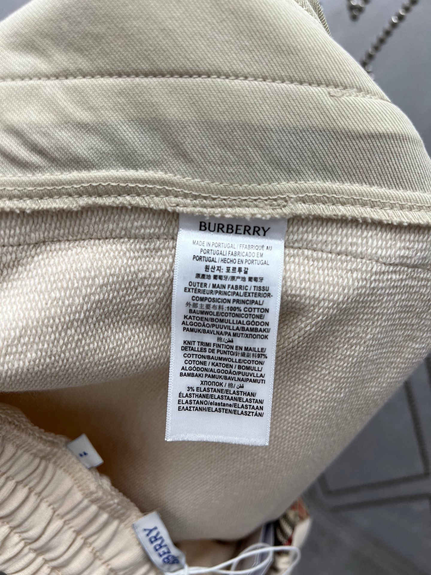 Cream shorts with care label tag and woven fabric texture
