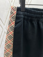 Navy shorts with elastic waistband and plaid trim side pocket
