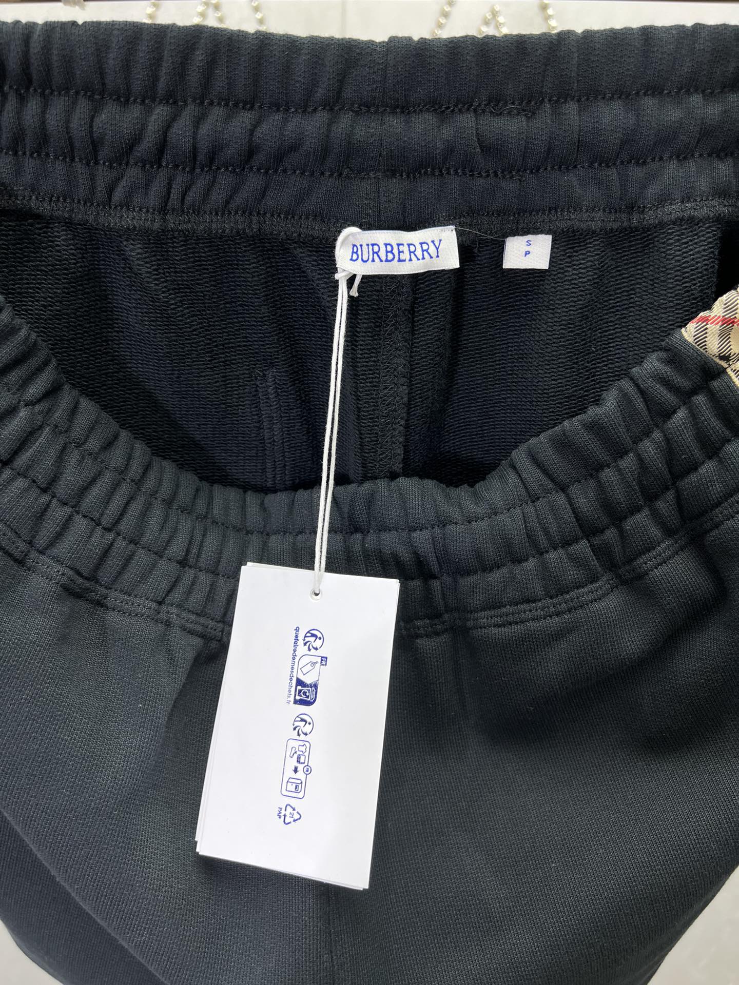 Navy shorts with elastic waistband and attached brand tag