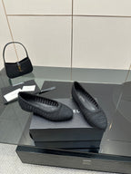 Women’s Chanel dark gray knit ballet flats, side view with woven texture and low heel