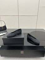 Women’s Chanel dark gray knit flats with textured upper, side angle on display