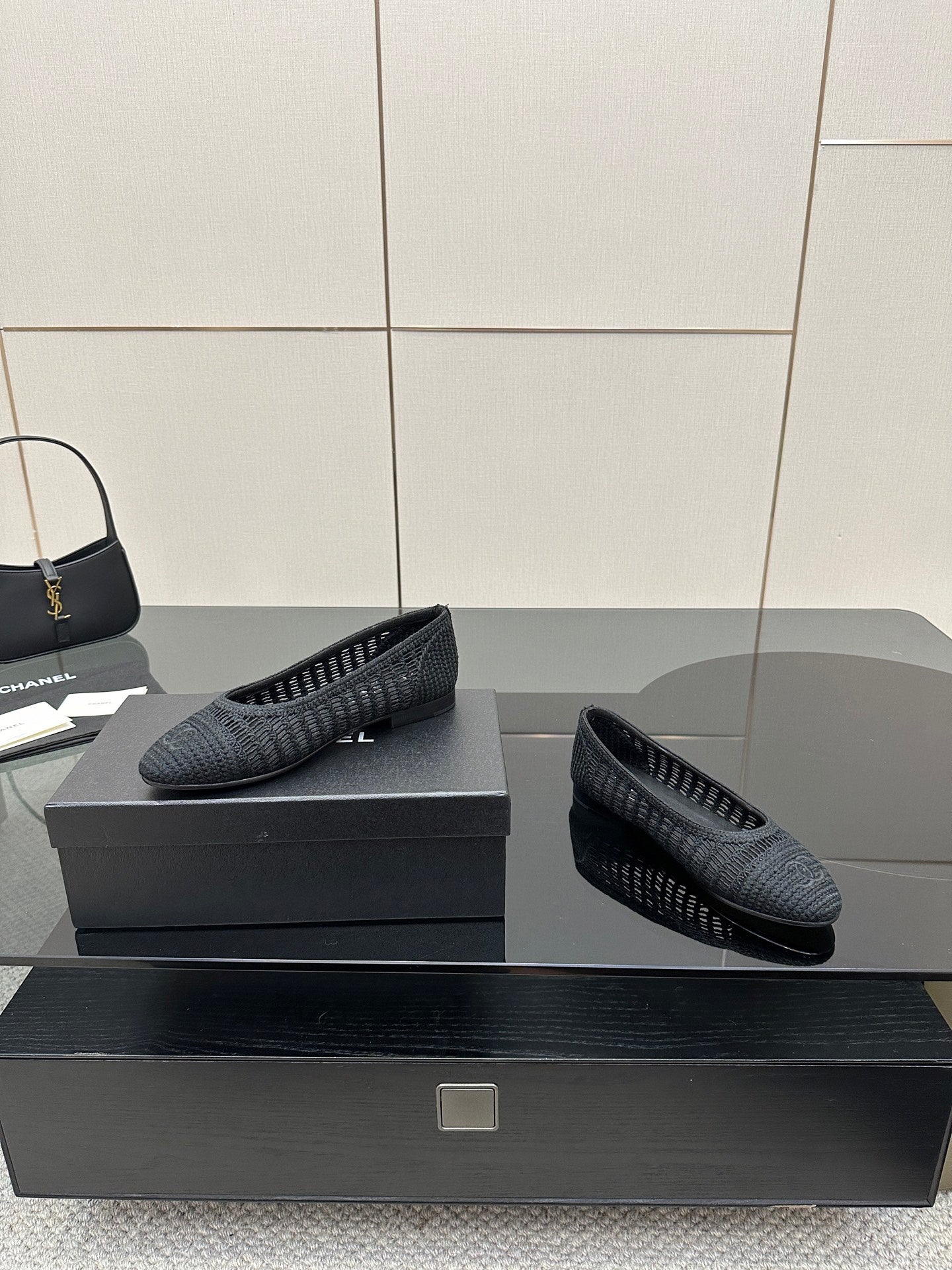 Women’s Chanel dark gray knit flats with textured upper, side angle on display