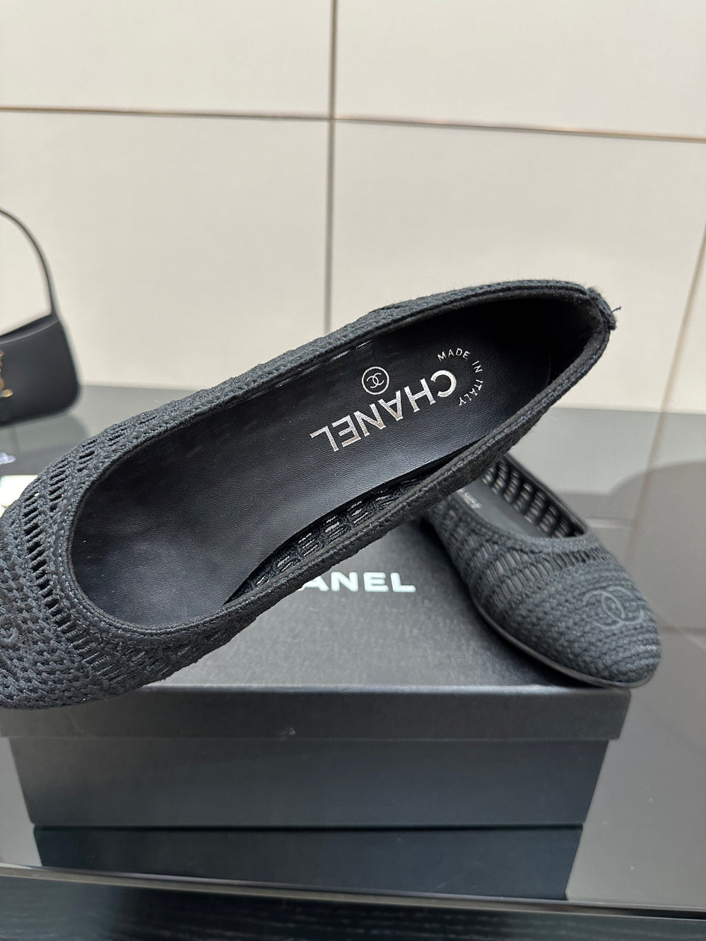 Women’s Chanel dark gray knit flats with CHANEL logo and “CHANEL” branding on lining