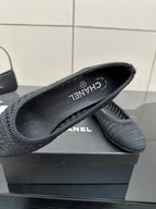 Women’s Chanel dark gray knit flats with CHANEL logo and “CHANEL” branding on lining