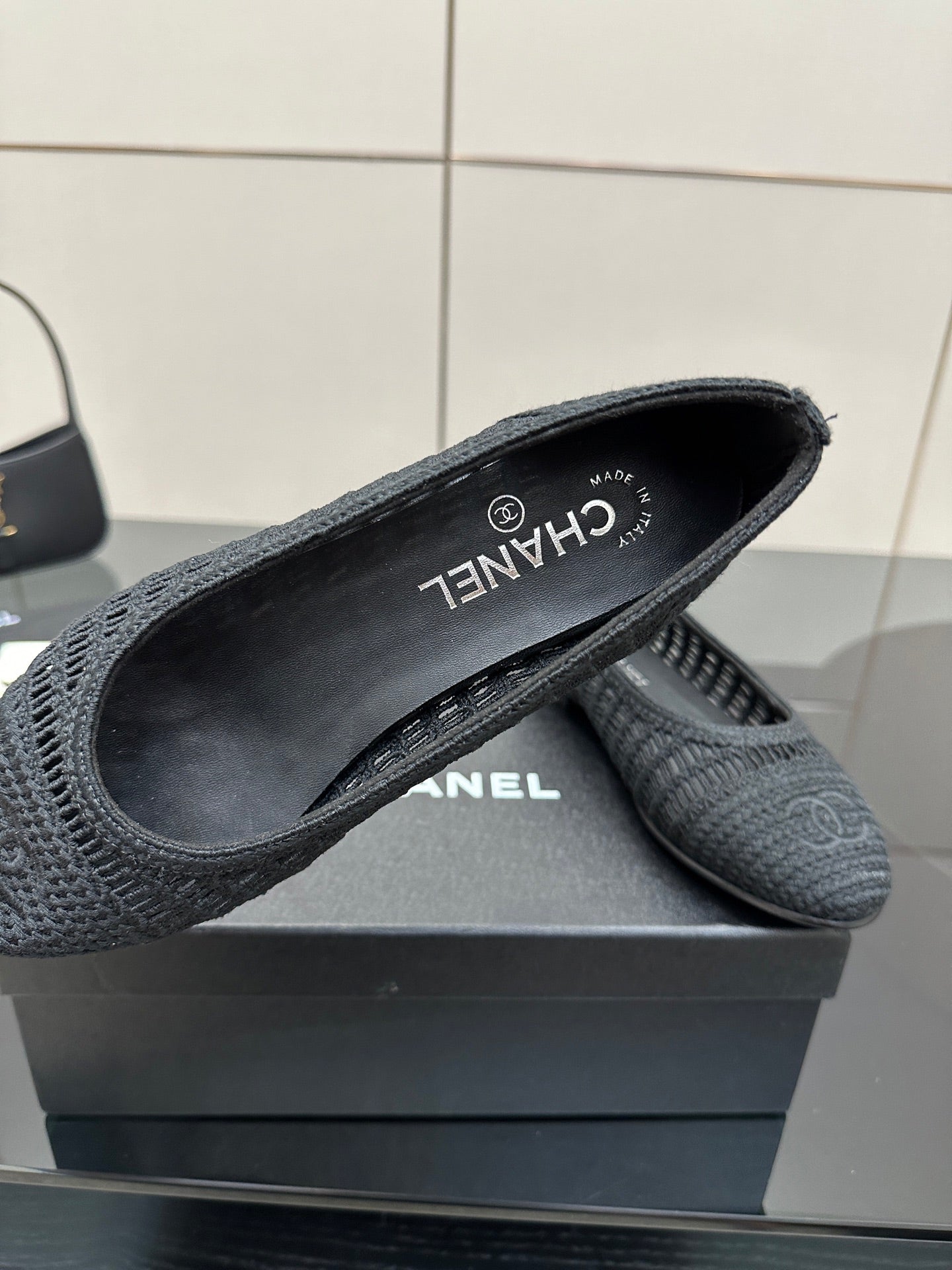 Women’s Chanel dark gray knit flats with CHANEL logo and “CHANEL” branding on lining
