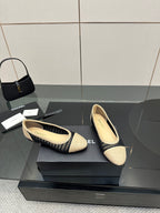 Chanel ladies ballet flats, side view of beige knit upper with navy trim band