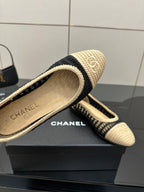 Chanel ladies ballet flats, close-up of beige insole with CHANEL logo and navy trim