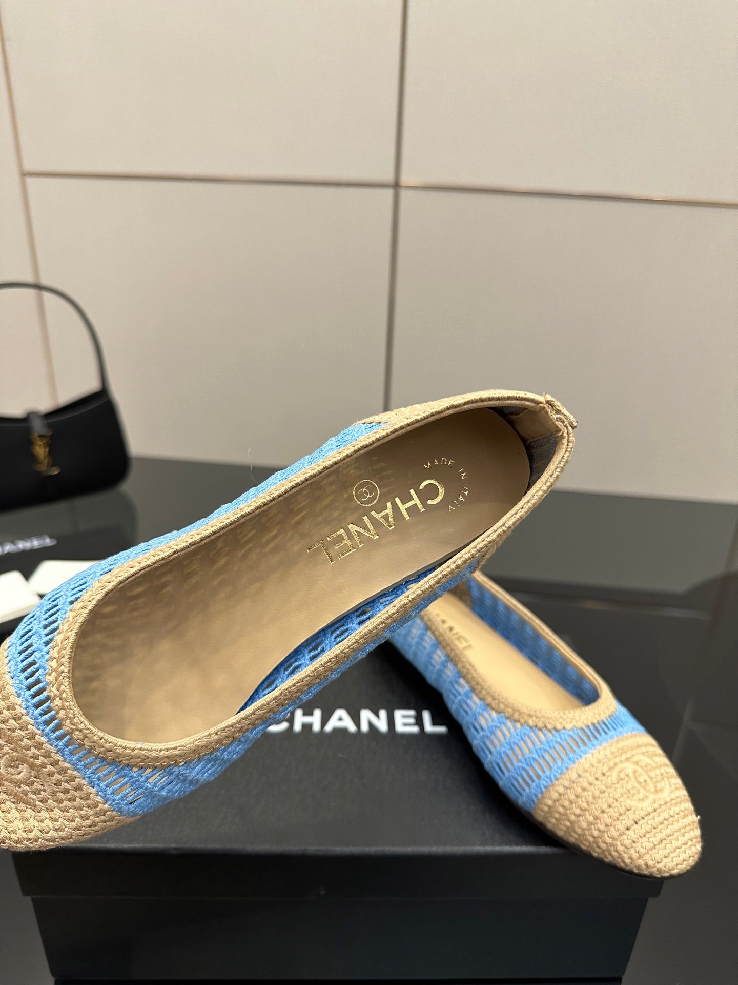 Chanel ladies woven flats close-up, gold-brown insole with blue fabric exterior