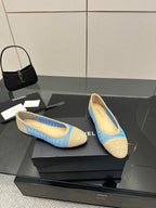 Chanel ladies woven slip-on flats with blue trim and beige uppers, side view