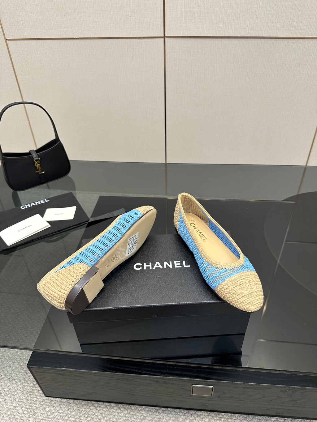 Chanel ladies slip-on flats, front view pair with blue knit stripe
