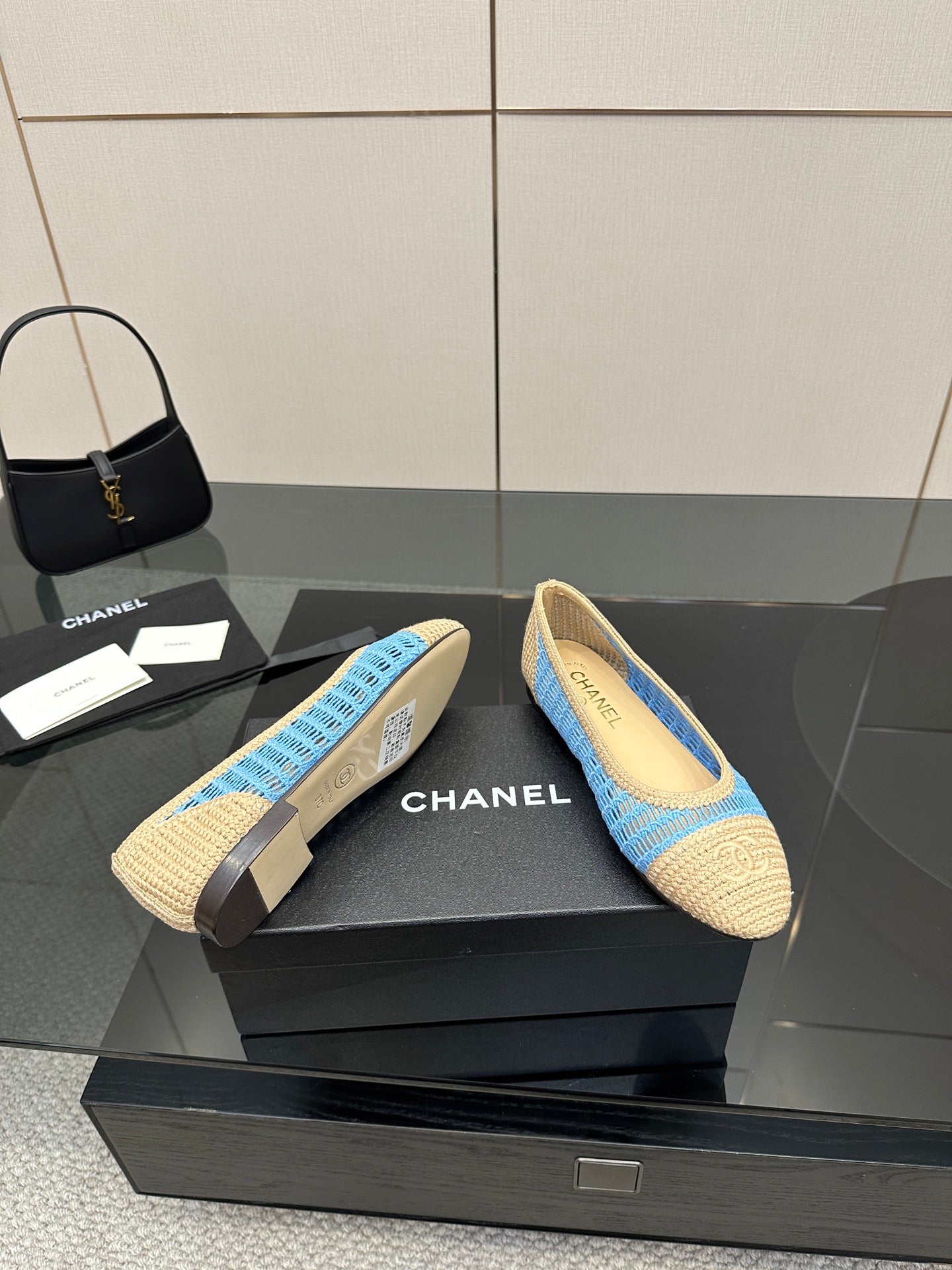 Chanel ladies slip-on flats, front view pair with blue knit stripe