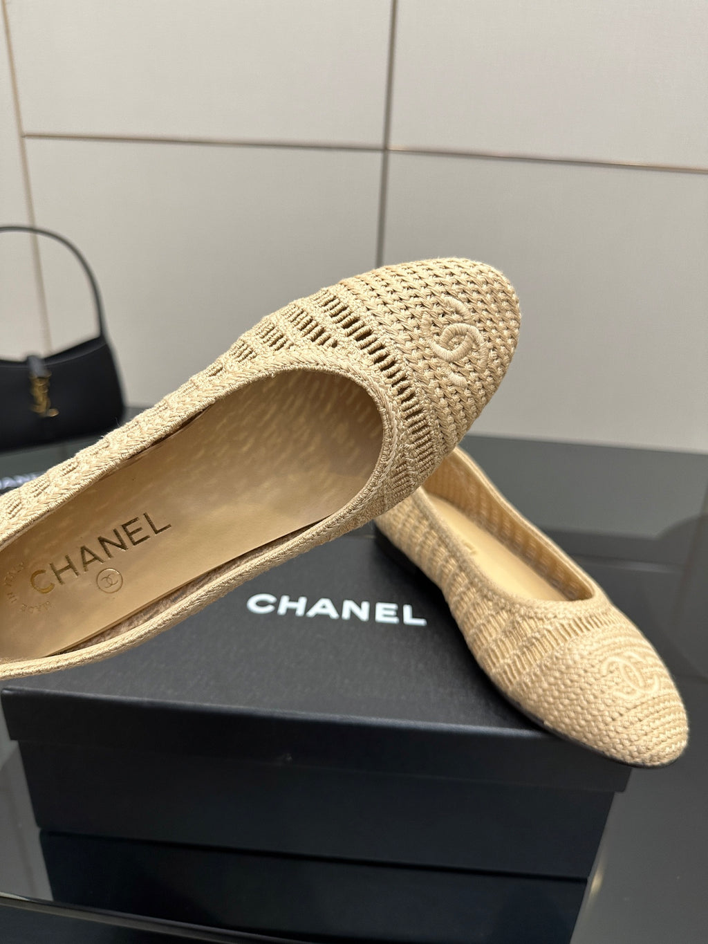 Chanel woven flat slip-on, light beige textured upper and “Chanel” logo insole
